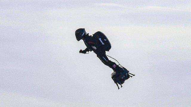 Franky Zapata stands on his jet-powered "flyboard" after he took off from Sangatte, northern France