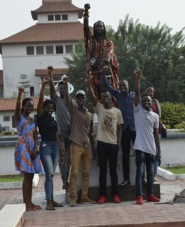 प्रतिमा हटाने के बाद खाली हुई जगह पर जश्न मनाते छात्र और प्रवक्ता