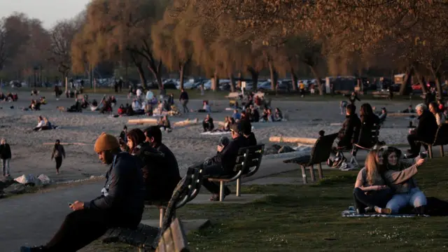 People gather at sunset, during the coronavirus disease (COVID-19) outbreak, at Golden Gardens Park in Seattle, Washington, U.S. March 21, 2020