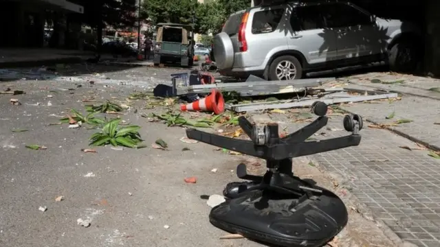 Debris strewn across a road in Beirut after gunfire erupts during protest against the judge investigating last year's blast at the city's port (14 October 2021)