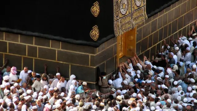 朝觐麦加的穆斯林朝圣者围绕着天房行走，想要亲吻嵌在上面的黑石