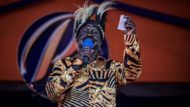 Kenya's Azimio La Umoja Party (One Kenya Coalition Party) presidential candidate Raila Odinga, wearing a traditional Luo hat, addresses the crowd during a campaign rally in Jomo Kenyatta International Stadium in Kisumu, on August 4, 2022 in Kisumu, Kenya