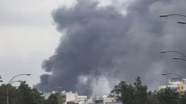 Smoke is seen rising over Darnytskyi district of Kyiv