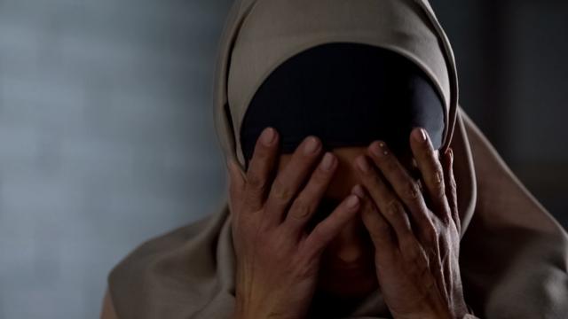 Muslim woman hiding her face