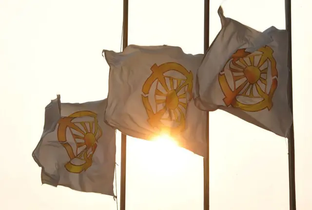 Unification Church flags are hoisted at half-mast at the church's Seoul headquarters on September 3, 2012 after the death of church leader Sun Myung Moon. The self-styled messiah from South Korea who founded the church, famed for its mass weddings and business empire spanning cars to sushi, died at the age of 92 after being hospitalised for complications from pneumonia. AFP PHOTO / KIM JAE-HWAN (Photo credit should read KIM JAE-HWAN/AFP/GettyImages)