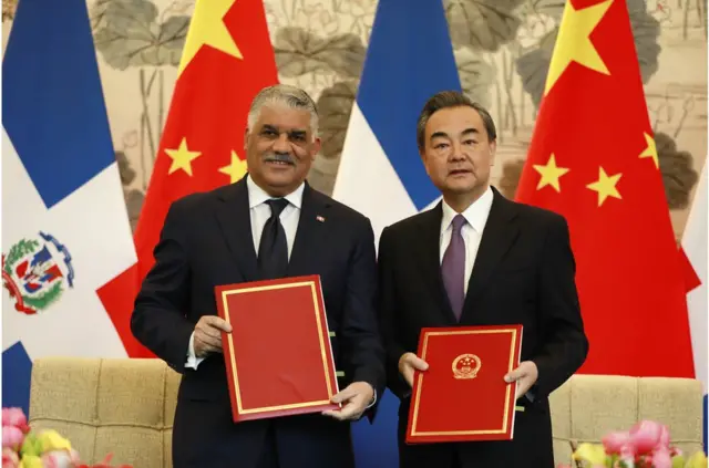 Dominican Republic Foreign Minister Miguel Vargas (L) and China"s Foreign Minister Wang Yi show documents after a signing ceremony where they formally established diplomatic relations between the two countries at Diaoyutai State Guest-house in Beijing, China, 01 May 2018. The Dominican Republic announced 01 May 2018 that they are establishing formal diplomatic relations with China and breaking diplomatic ties with Taiwan. EPA/HOW HWEE YOUNG