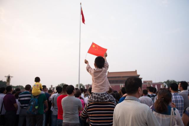 People wait for a flag ceremony at the Tiananmen square - China's symbolic political heart - prior to the 27th anniversary of what some people refer to as the "June 4 massacre, in Beijing on June 4, 2016, China.