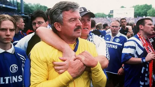 Juergen Moellemann is surrounded by fans who are - like him - trying to work out what is happening in Hamburg