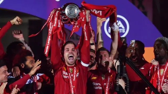 Liverpool captain Jordan Henderson lifts the Premier League trophy