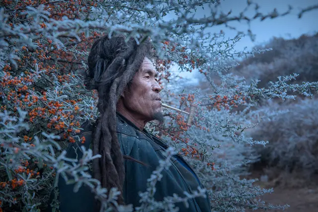 A pipe-smoking man in Liangshan Yi Autonomous Prefecture, China.