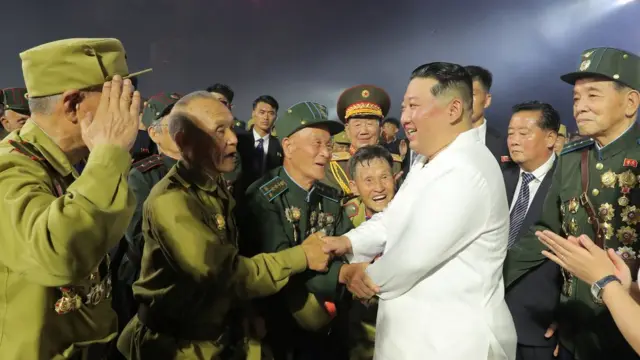 North Korea's leader Kim Jong Un meets a group of Korean War veterans at the 2022 Victory Day celebrations