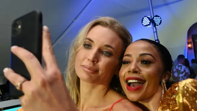 Two South African reality TV stars, Roxy Louw and Kelly Khumalo, take a selfie together.