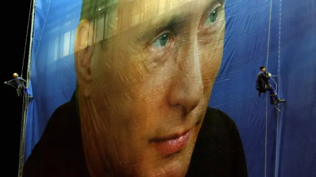 Робітники у Росії вішають величезний плакат Путіна