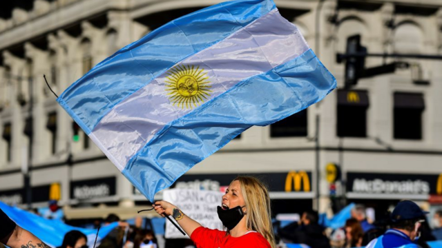 A woman carrying an Argentina flag takes part in a protest in Buenos Aires