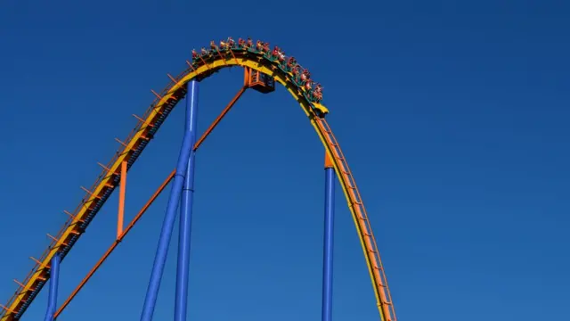 Carriage about to fall down steep drop on rollercoaster