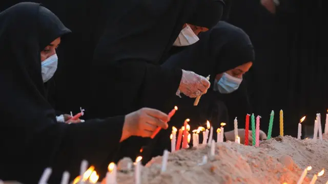 Iraqi women light candles during a memorial ceremony on the tenth day of the month of Muharram which marks the peak of Ashura, in the holy city of Karbala, on August 30, 2020. - Ashura is a period of mourning in remembrance of the seventh-century martyrdom Imam Hussein, who was killed in the battle of Karbala in modern-day Iraq, in 680 AD. (Photo by AHMAD AL-RUBAYE / AFP) (Photo by AHMAD AL-RUBAYE/AFP via Getty Images)