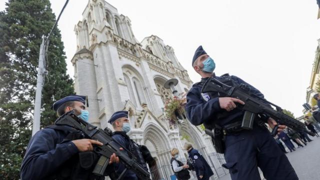 Police officers stand near the Notre-Dame basilica