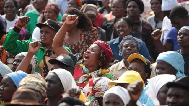 Thousands of Zanu PF supporters march through the streets of Harare in solidarity with their President Robert Mugabe in Harare, Zimbabwe, Wednesday 27 July 2016