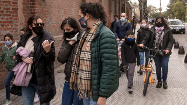 A group of mothers walks with their kids