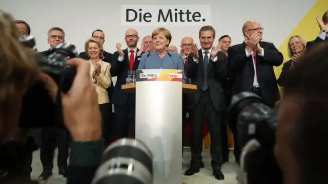 German Chancellor Angela Merkel dey talk to leaders of her party Christian Democrat (CDU) after she win di Sept. 24, 2017 election.