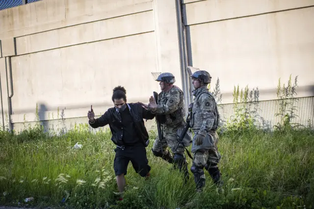 9. Minnesota national guardsmen disperse demonstrators during protests resulting from the killing of an unarmed black man, George Floyd, by police