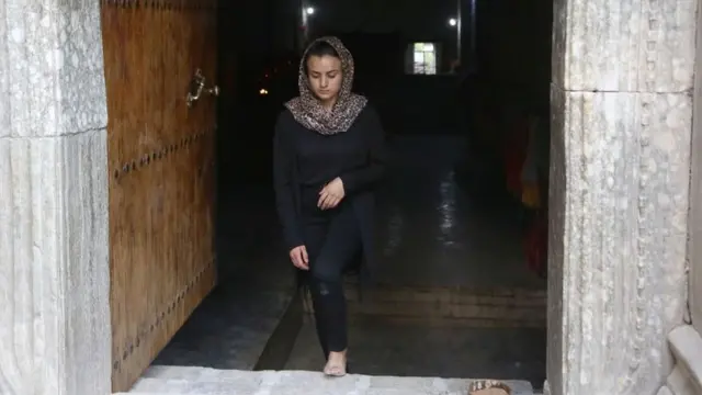 Yazidi woman Ashwaq Haji, allegedly used by the Islamic State group (IS) as a sex slave, visits the Lalish temple in tribute to the jihadists' victims from her village of Kocho near Sinjar