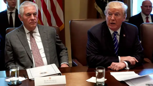 U.S. Secretary of State Rex Tillerson (L) listens to U.S. President Donald Trump