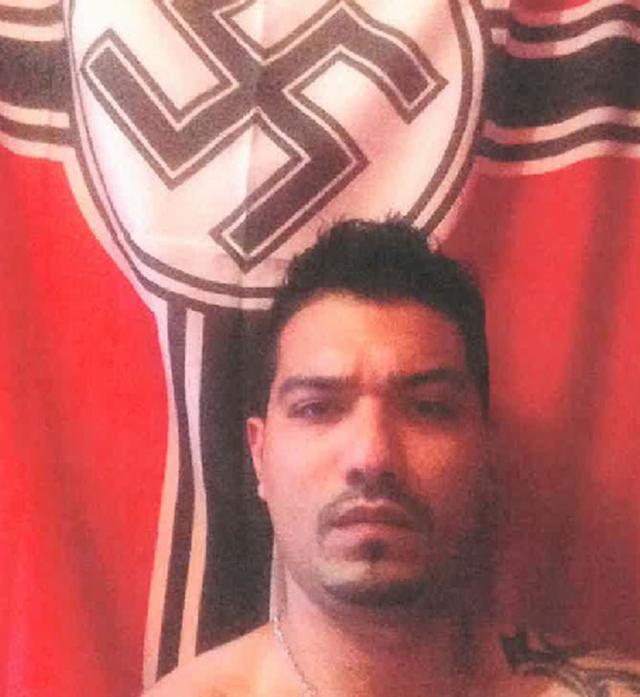 Ashkan Ebrahimi in front of Nazi flag