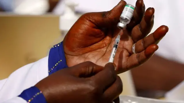 Une infirmière se prépare à administrer le vaccin Covid à un patient.