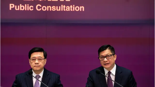 From left to right, Hong Kong Chief Executive John Lee and Hong Kong Secretary for Security Tang Ping-keung are attending a government press conference on the Article 23 Legislation Public Consultation in Hong Kong, on January 30, 2024. The Hong Kong Government is starting public consultation on the Article 23 National Security legislation today. (Photo by Vernon Yuen/NurPhoto via Getty Images)