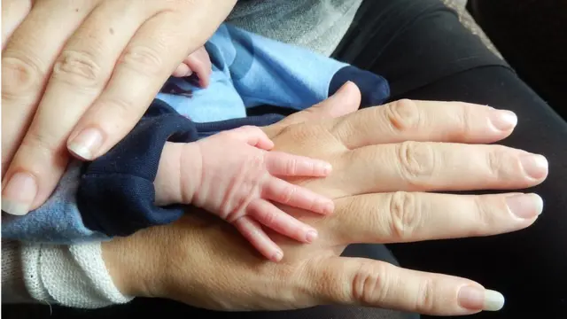 Adult and baby hands