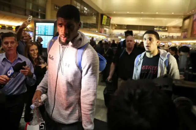 The players were mobbed by reporters upon their return to LAX airport