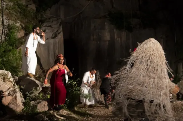 Cast members practise a scene.