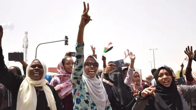 Sudanese demonstrators gather in a street in central Khartoum on April 11, 2019, after one of Africa's longest-serving presidents was toppled by the army