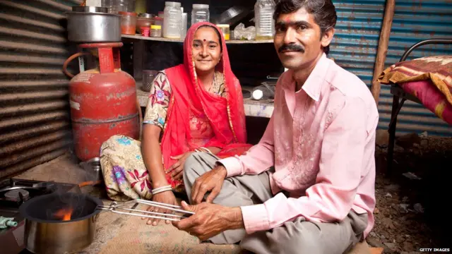 Rural portrait of loving Indian Rajasthani couple in the kitchen