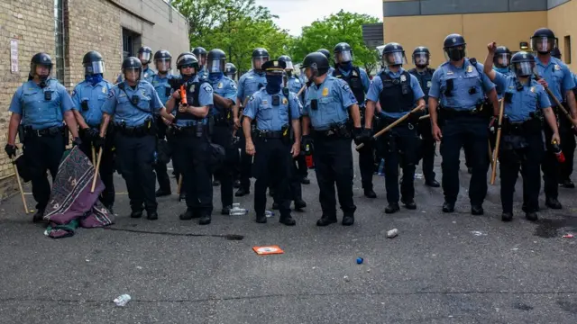 一隊明尼阿波利斯市警察手持防暴裝備在示威現場列陣（27/5/2020）