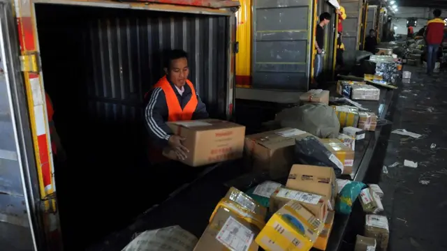 Workers sorting out packages at an express delivery company in Beijing