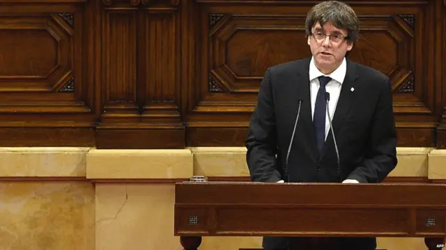 Carles Puigdemont gives a speech at the Catalan regional parliament in Barcelona on October 10, 2017.