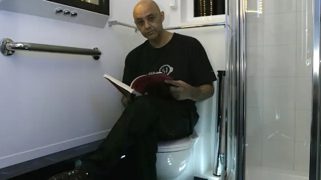 Interior designer Tony Alleyne sits in his 'Star Trek' theme studio apartment bathroom May 16, 2003 in Hinckley, Leicestershire, England. The apartment took nearly 10 years to redesign in the style of the 'Star Trek' Starship Enterprise and is now on sale for approximately US$1.7 million.