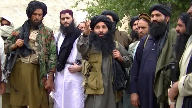 A grab taken from an undated handout video released by the Tehrik-e-Taliban Pakistan (TTP) shows its head Mullah Fazlullah (centre) at an undisclosed location at Pak-Afghan border (file photo)