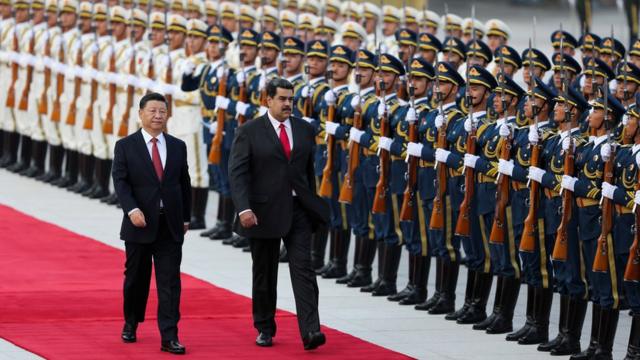 Chinese President Xi Jinping walks next to Nicolas Maduro during a visit to Beijing, September 2018