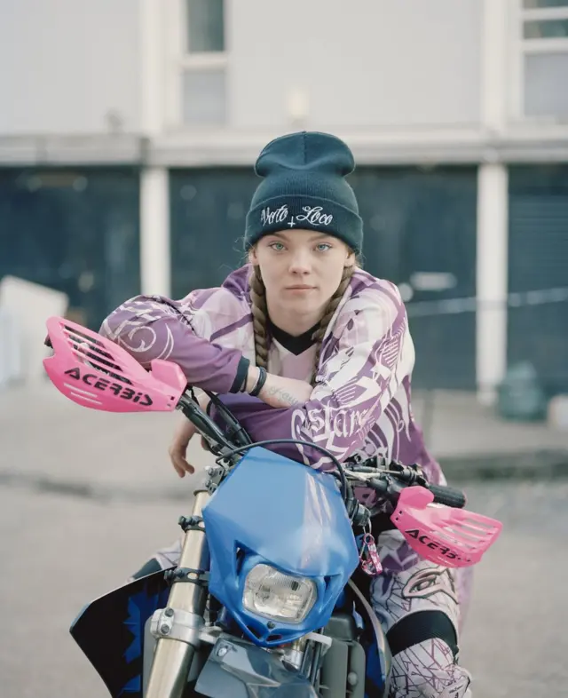 A young girl on a motorcycle