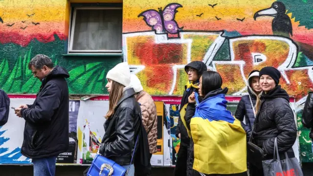 Visitors and refugees from Ukraine queue in the street to enter the "Beacon of Ukraine" gathering in Berlin, Germany, 10 April 2022