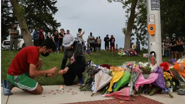 People light candles at a makeshift memorial in London, Ontario, Canada June 7, 202