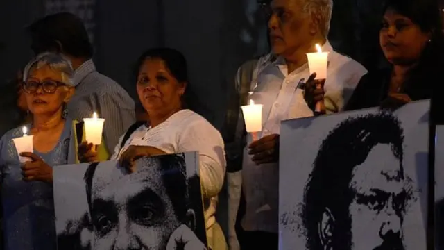 Sandya Eknelygoda (3R), wife of a victim of enforced disappearance journalist Prageeth Ekneligoda is seen among a crowd of demonstrators, holding a candlelight vigil. The 'January Is Still Black' vigil in remembrance of the slain and disappeared journalists. The demonstrators gathered in Colombo to show solidarity in protecting media professionals in the country in Colombo, Sri Lanka on January 28, 2020. (Photo by Akila Jayawardana/NurPhoto via Getty Images)