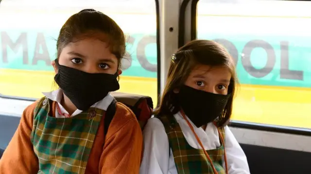 મોઢા પર માસ્ક સાથે બે વિદ્યાર્થીનીઓ