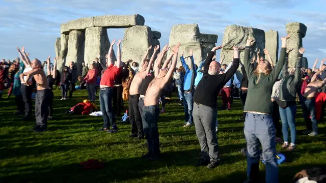 Visitors celebrate summer solstice and the dawn of the longest day of the year at Stonehenge on June 21, 2019 in Amesbury, England.