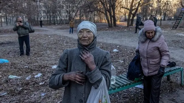 Local residents from the residential building which was hit by artillery shelling stand in front of the building, in Kyiv, Ukraine, 15 March 2022