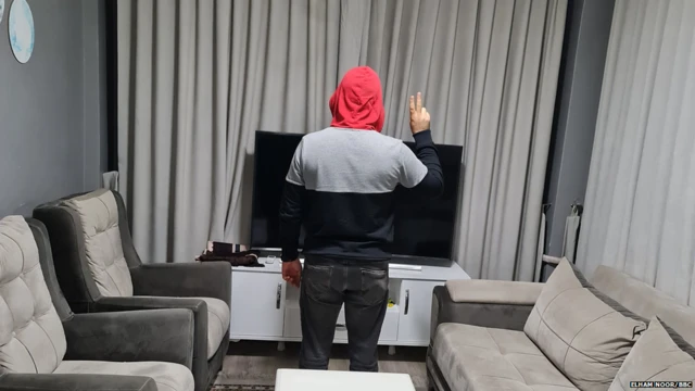 Noor with his back to the camera