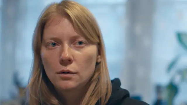 Uliana looking shocked as she talks to her father about the war